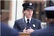 Woman in uniform speaking at the Memorial Day service