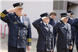 Uniformed individuals saluting