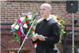 Man in black speaking at Memorial Day service