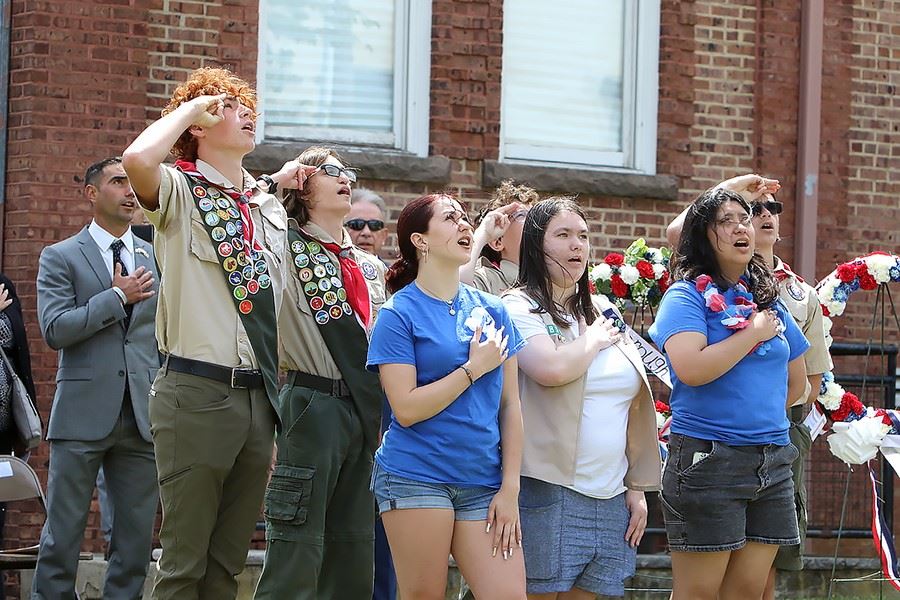 Crowd saluting the flag