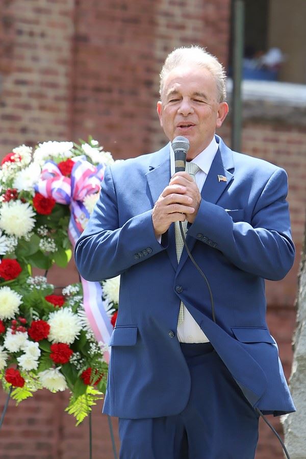 Man in blue suit performing at Memorial Day service