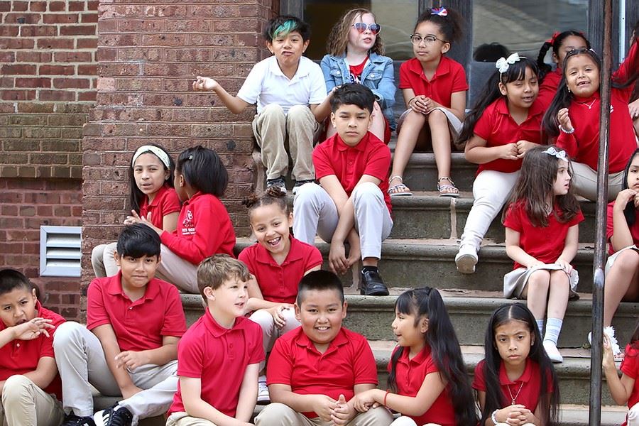 Kids in red watching the Memorial Day service