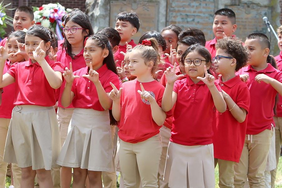 Close up of kids in red performing at the Memorial Day Service